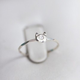 Initial ring with hand stamping in a cat head shape
