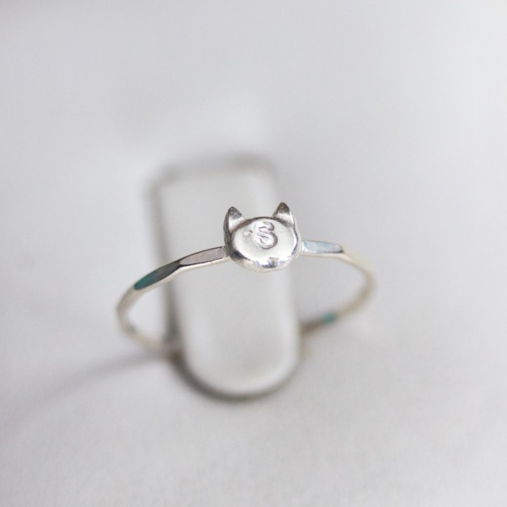 Initial ring with hand stamping in a cat head shape Initial ring with hand stamping in a cat head shape