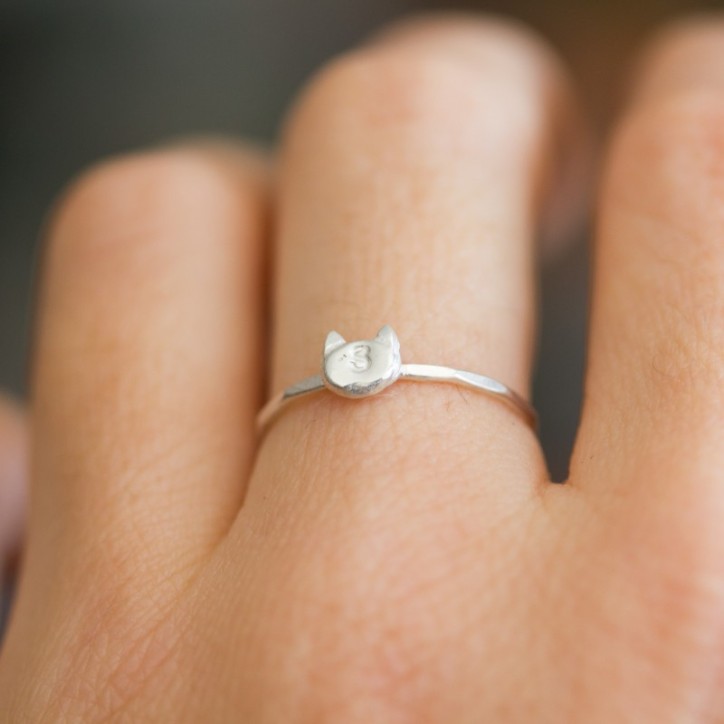 Initial ring with hand stamping in a cat head shape Initial ring with hand stamping in a cat head shape