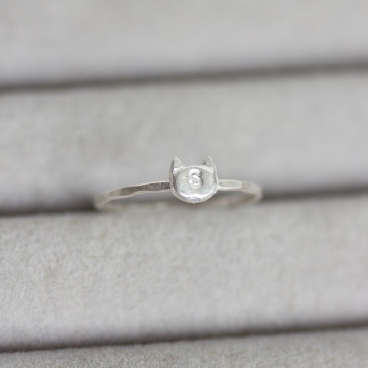 Initial ring with hand stamping in a cat head shape Initial ring with hand stamping in a cat head shape
