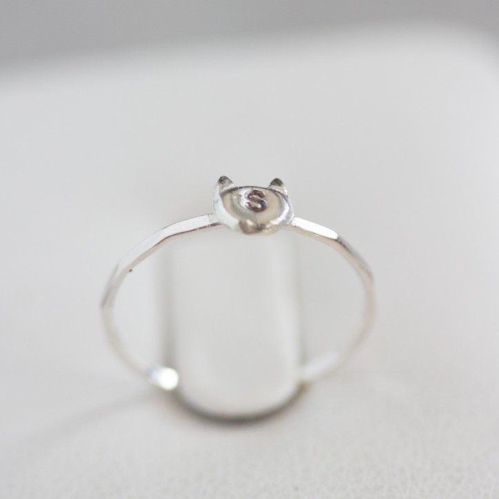 Initial ring with hand stamping in a cat head shape Initial ring with hand stamping in a cat head shape
